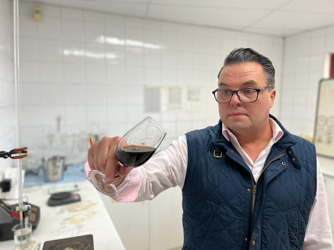 Eddy Rossi assessing a glass of Exeter Vineyard wine
